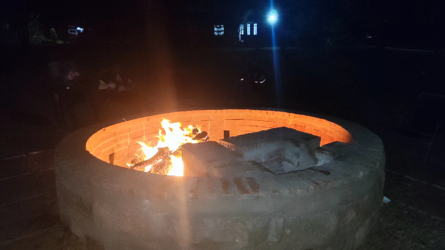Bonfire glowing at night at Thiba River Camp